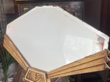 a large mirror sitting on top of a wooden table