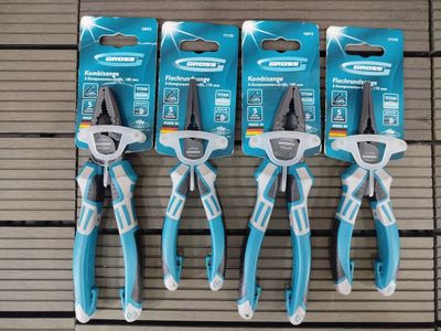 four blue pliers are lined up on a wooden surface