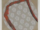 une photo représentant un dessin d'un ruban rouge sur un napperon