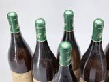 six bottles of wine are lined up in a row