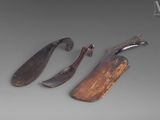three pieces of wood and a knife on a gray surface