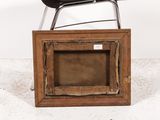 a black chair sitting on top of a wooden frame