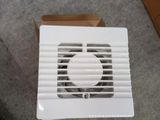 a white exhaust fan sitting on the floor next to boxes