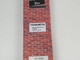 a close up of a red brick wall with a barcode on it