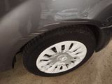 a close up of a car ' s tire with a denting on it
