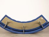 an image of a blue and tan rocking chair on a concrete floor