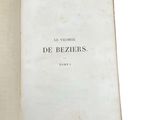 an open book on a white surface with the title of de beziers