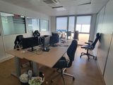 une pièce équipée d'un bureau, de chaises et d'un ordinateur posé dessus