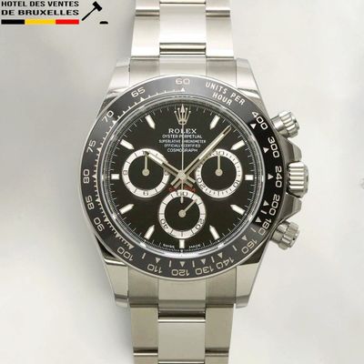 rolex watch with black dial and stainless bracelet on a white background