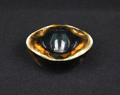 a close up of a glass object on a black surface