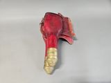 a red shoe that has a gold heel on it