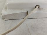 a close up of a white electrical device with a cord