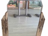a mirror that is sitting on the floor in front of a table