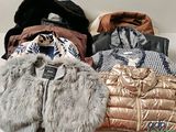 a pile of jackets and jackets sitting on a table