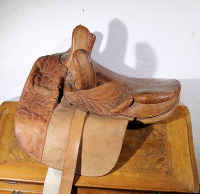 a wooden box with a pair of cowboy boots on top of it