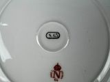 a white plate with a red and black design on it