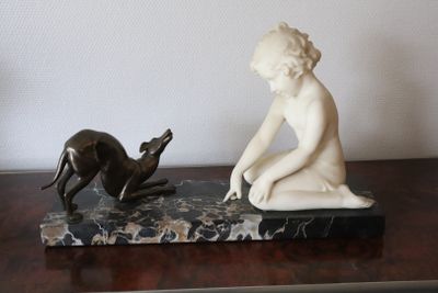 a statue of a child and a dog on a table