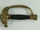 a gold and black sword on a white surface