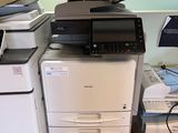a stack of office printers and a printer on the floor