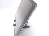 a tablet computer sitting on a stand on a white surface