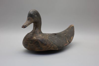 un canard en bois posé sur une table