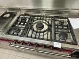 a gas stove in the middle of a commercial kitchen