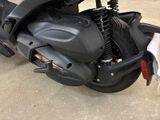 a black motorcycle parked in a parking lot next to a building