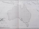 an old map of australia and australia with a bird flying over it