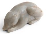 a small statue of a bear on a white surface