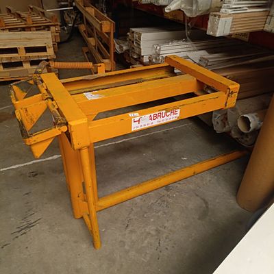 une table jaune sur laquelle est posé un panneau, dans un entrepôt