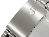 a close up of a watch on a white surface