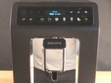 a black coffee maker sitting on a wooden table