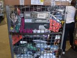 a large metal cart with many items on it in a warehouse