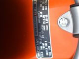 a close up of a steering wheel on an orange motorcycle