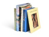 a lot of books that are stacked on top of each other