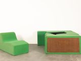 two green chairs and a small table in a room