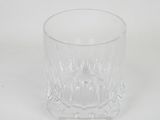 a close up of a glass cup on a white surface