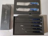 four knives in a box on a table