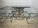 a glass table and two stools in a room