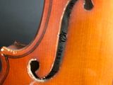 a close up of a violin that is sitting on a table