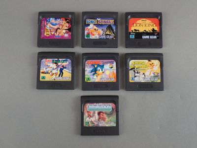 several video game cartridges are lined up on a table