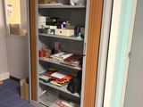 a large open cabinet in the corner of a room