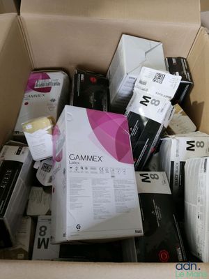 a cardboard box full of electronic devices and other items