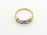 a close up of a gold ring with three diamonds on it
