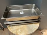 a metal pan sitting on top of a table on a tile floor