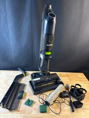 a close up of a vacuum on a wooden table with other items
