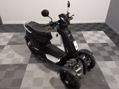 un scooter garé sur un sol à damier