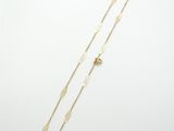 a gold necklace and a gold bracelet on a white background