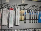 many different pens and pencils hanging on a rack