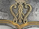a close up of a metal object with a crown on top of it